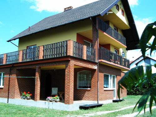 a large brick building with a balcony on it at Pokoje u Wiki - Mieroszyno in Jastrzębia Góra