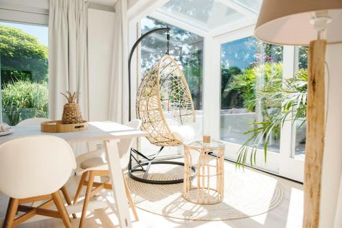 a room with a table and chairs and a window at Luxury villa on peaceful location. Boat optional in Vinkeveen