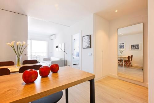 two apples on a wooden table in a living room at Nogalera Terrace by Madflats Collection in Torremolinos
