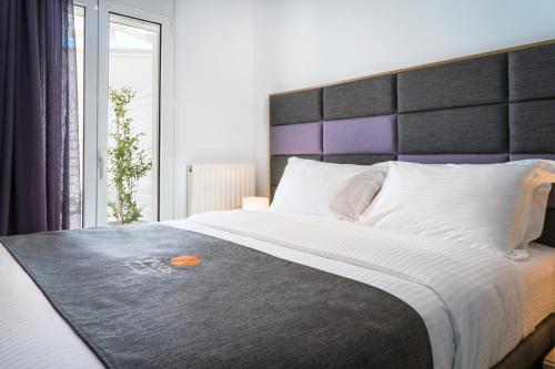 a bedroom with a large bed with a large headboard at Talos Luxury Suites in Kounoupidhianá