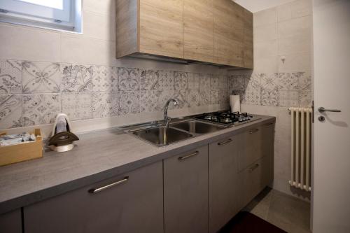 a kitchen with a sink and a stove at La Casa di Montegrosso in Matera