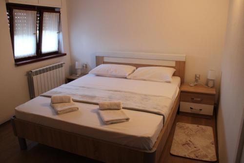 a bedroom with a bed with two towels on it at APARTMAN KRUNA RD Opatija, Matulji, Rukavac in Rukavac