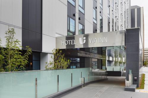 a hotel v villin sign in front of a building at Via Inn Prime Kyotoeki Hachijoguchi in Kyoto