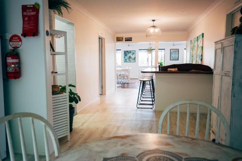 a dining room and kitchen with a table and chairs at Yeppoon Beachhouse in Yeppoon