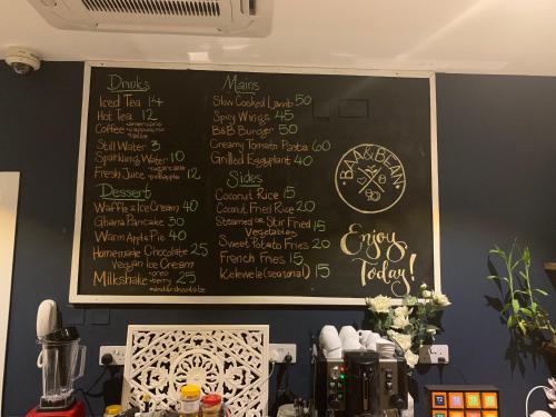 a chalkboard with a menu on a wall at Accra Luxury Apartments at The Gallery in Accra