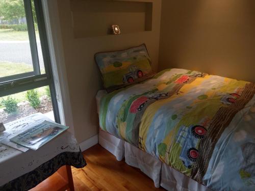 a small bedroom with a bed and a window at Cradle at Casa Blanca Country Retreat in Barrington
