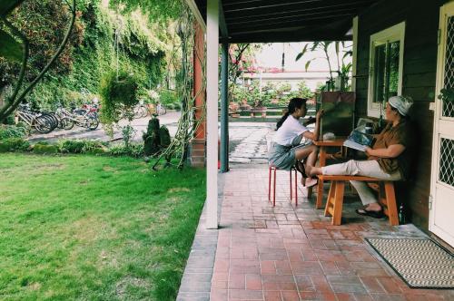 two women sitting at a table on a porch at Puli Islet Inn in Puli