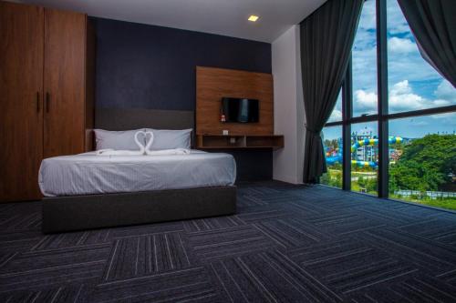 a hotel room with a bed and a large window at We Hotel Langkawi in Kuah