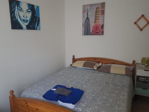 a bedroom with a bed and a painting on the wall at Sweet Apartment Bianchini in Bologna