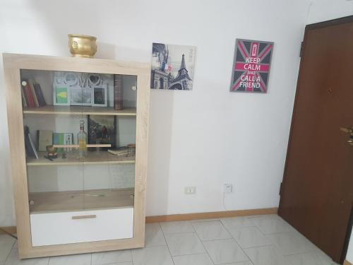 a room with a book shelf and a door at Sweet Apartment Bianchini in Bologna