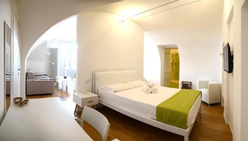 a bedroom with a bed and a living room at Ca del Lac in Castro
