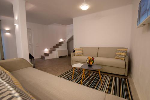 a living room with a couch and a table at Thea Luxury Resort in Fira