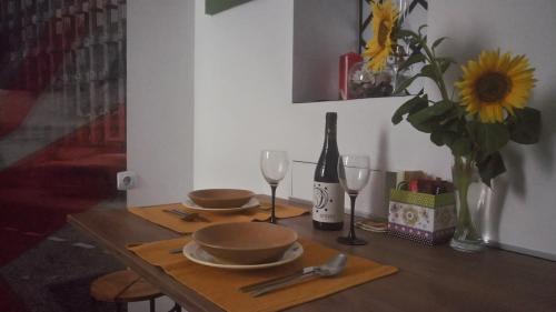 a table with two glasses and a bottle of wine at sunflower in Budapest