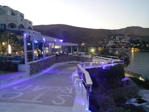 a building with a view of the water at night at Kazonis Studios in Kalymnos