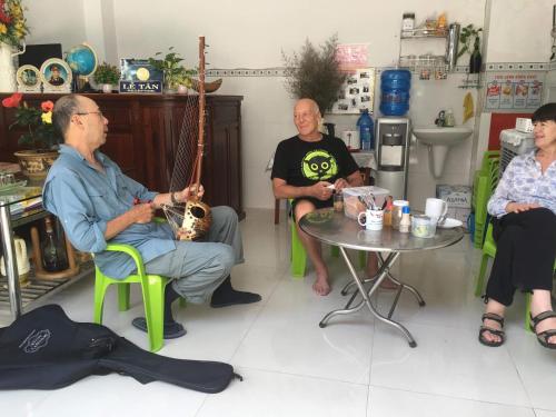 a group of people sitting around a table at NGỌC QUÝ Mini House in Quy Nhon