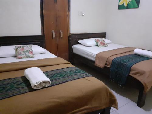 Cama ou camas em um quarto em Griya Bun Sari