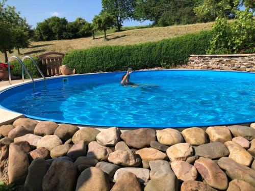 a person swimming in a pool of water at Ferienwohnung Kuhn in Rhumspringe