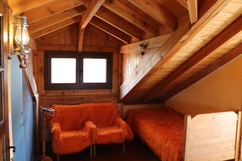 an attic room with a bed and a window at Casa Kedrova, Mountain Voras-Kaimaktsalan Edessa in Kedhróna