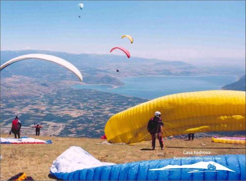 a group of people flying kites on top of a mountain at Casa Kedrova, Mountain Voras-Kaimaktsalan Edessa in Kedhróna