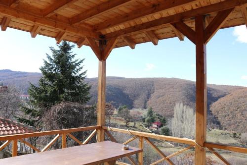 a view from the porch of a house with a table at Casa Kedrova, Mountain Voras-Kaimaktsalan Edessa in Kedhróna
