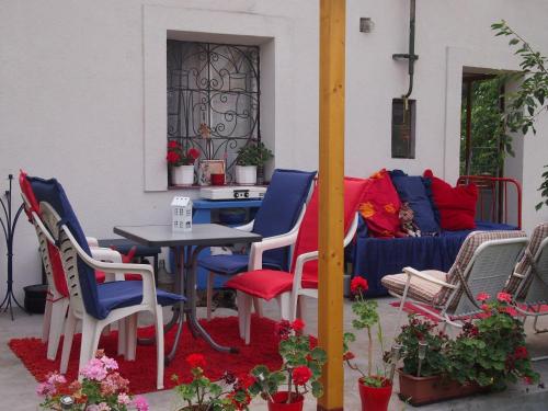 a patio with a table and chairs and a couch at DéeL apartman in Nyíregyháza