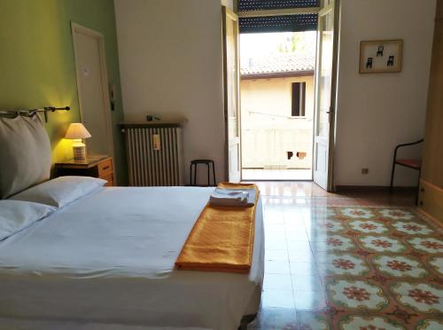 a bedroom with a bed with a wooden table on it at Ostello delle cartiere in Toscolano Maderno