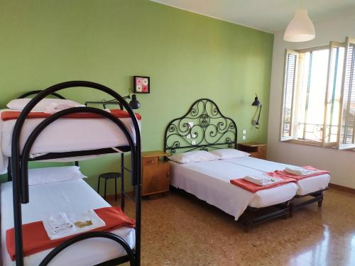 two bunk beds in a room with green walls at Ostello delle cartiere in Toscolano Maderno