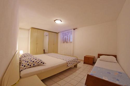 a small bedroom with two beds and a window at Large and charming apartment near beach with big & sunny terrace in Sumartin