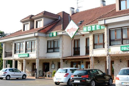 a hotel with cars parked in front of it at Hotel Capitán in Cangas de Onís