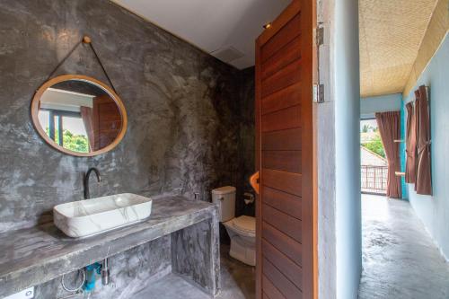 a bathroom with a sink and a mirror at Dreamcatcher Boutique Hotel in Bophut 