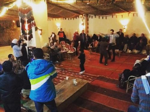 a group of people dancing in a room at badawiya farafra hotel in Qasr Al Farafirah