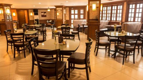 a restaurant with tables and chairs in a room at Rothman Hotel in Manila