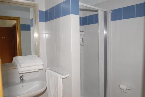 a bathroom with a white sink and a shower at Hotel Isola Di Mozia in Marsala