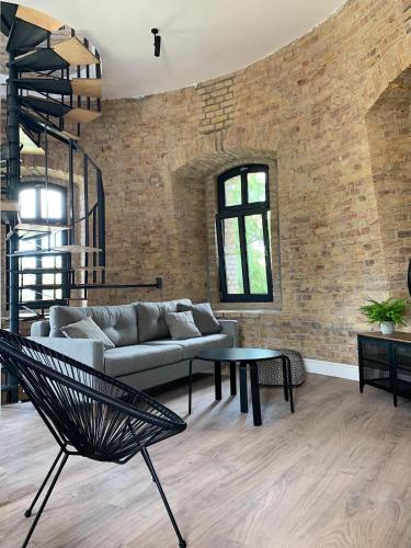 a living room with a couch and a table at Apartamenty Wieża - Tower Apartments in Wałcz