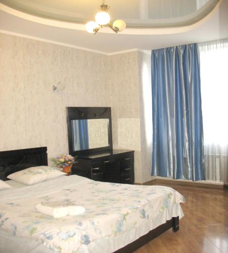 a bedroom with a bed and a dresser and a mirror at Tbilisi Comfort in Tbilisi City