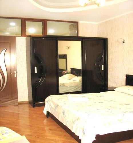 a bedroom with two beds and a large mirror at Tbilisi Comfort in Tbilisi City