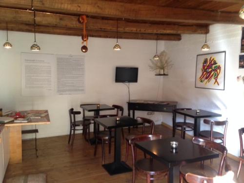 a dining room with tables and chairs and a tv at B&B Lo Straniero in Rivello