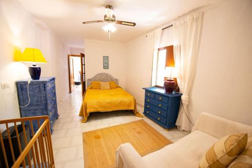 a bedroom with a bed and a blue dresser at Bonita casa con vistas El Chorro in El Chorro