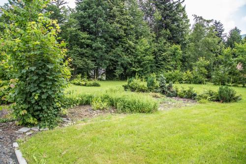 a garden with plants and trees in a field at hotel U lip Trojanovice in Frenštát pod Radhoštěm