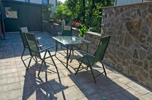 a table and four chairs on a patio at Apartments Drevi in Ljubljana