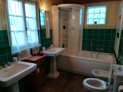 a bathroom with two sinks and a tub and a toilet at Casa della Musica in Verbania