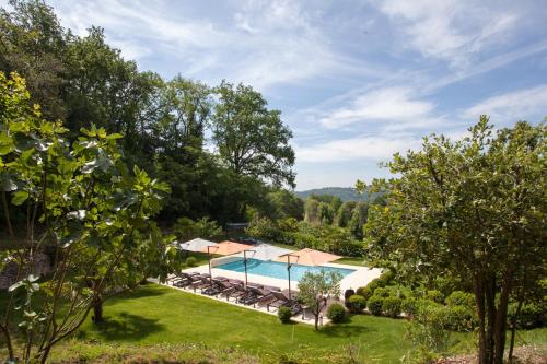 une vue aérienne d'une piscine dans un jardin dans l'établissement Les Hauts de Gageac Maison d'Hôtes de Charme, à La Roque-Gageac