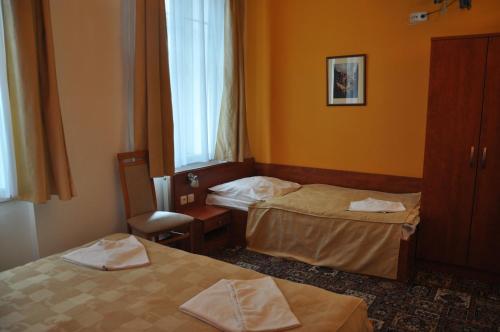 a hotel room with two beds and a window at City Central De Luxe in Prague