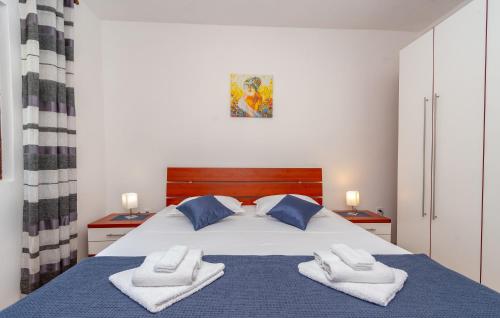 a bedroom with a bed with towels on it at Apartment Korina Vela Luka Gradina in Vela Luka