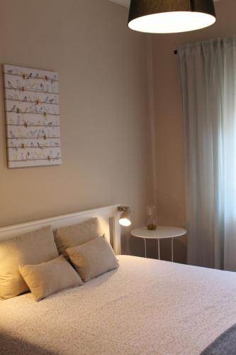 a bedroom with a bed with two pillows on it at Charming Baixa II in Lavradio