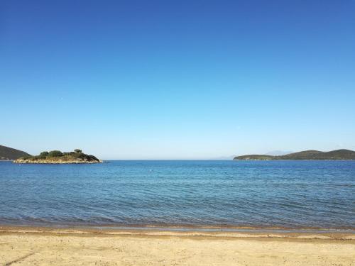 a large body of water with an island in the distance at Sea View Apartments Nikos in Nea Peramos