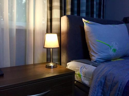 a bedroom with a bed and a table with a lamp at Westend Hotel Kyiv in Kyiv