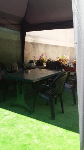 a table and chairs under a tent with potted plants at Apartament Stonel in Veliko Tŭrnovo