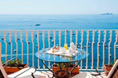 
a table topped with plates of food on top of a pier at Hotel Marincanto in Positano
