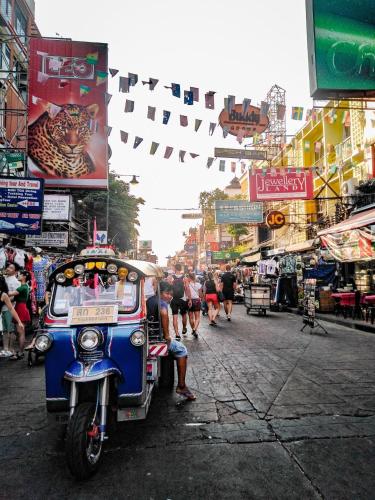 a motorcycle parked on a street in a city at SSIP Boutique Dhevej Bangkok in Bangkok